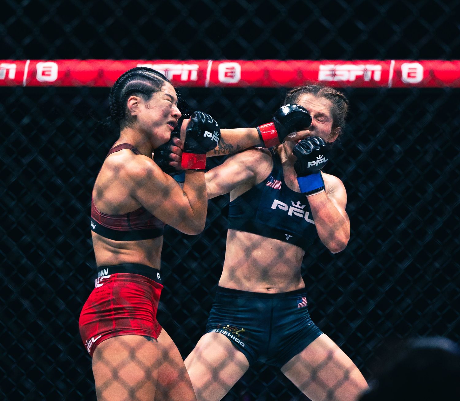 Two female MMA fighters exchange punches inside a cage during a PFL fight broadcast on ESPN.