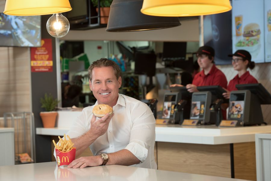 McDonald's restaurant interior with yellow pendant lamps and casual dining atmosphere.