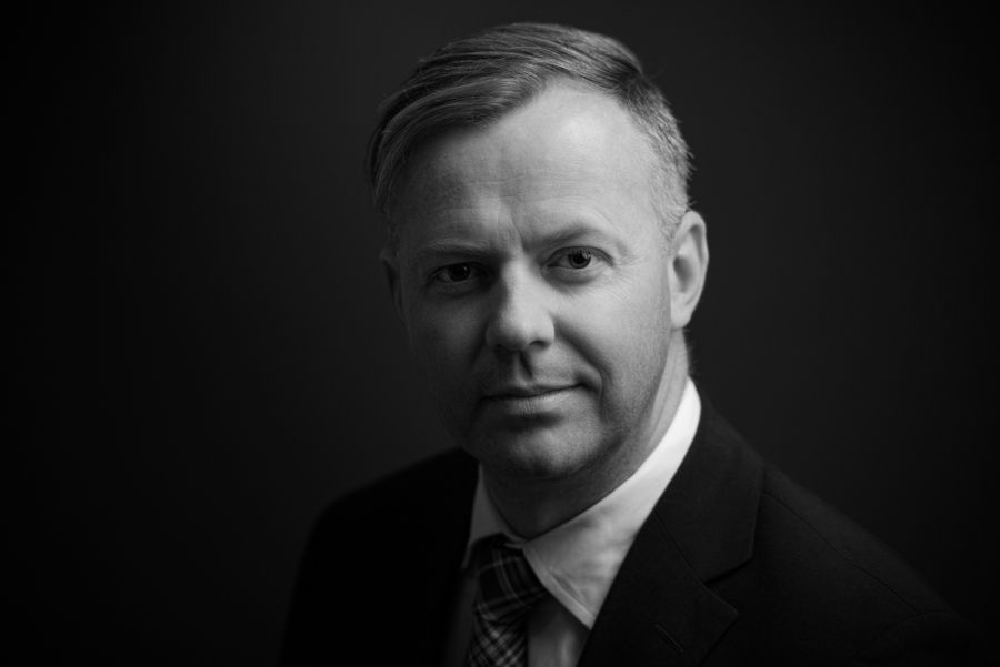 Dramatic black and white professional headshots with dark background.