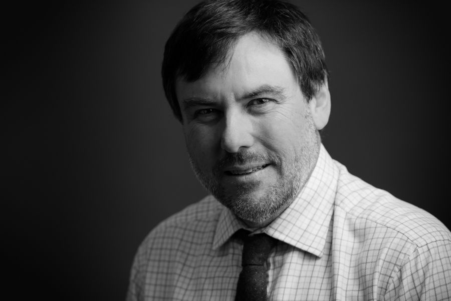 Professional black and white headshots showing various expressions and poses.