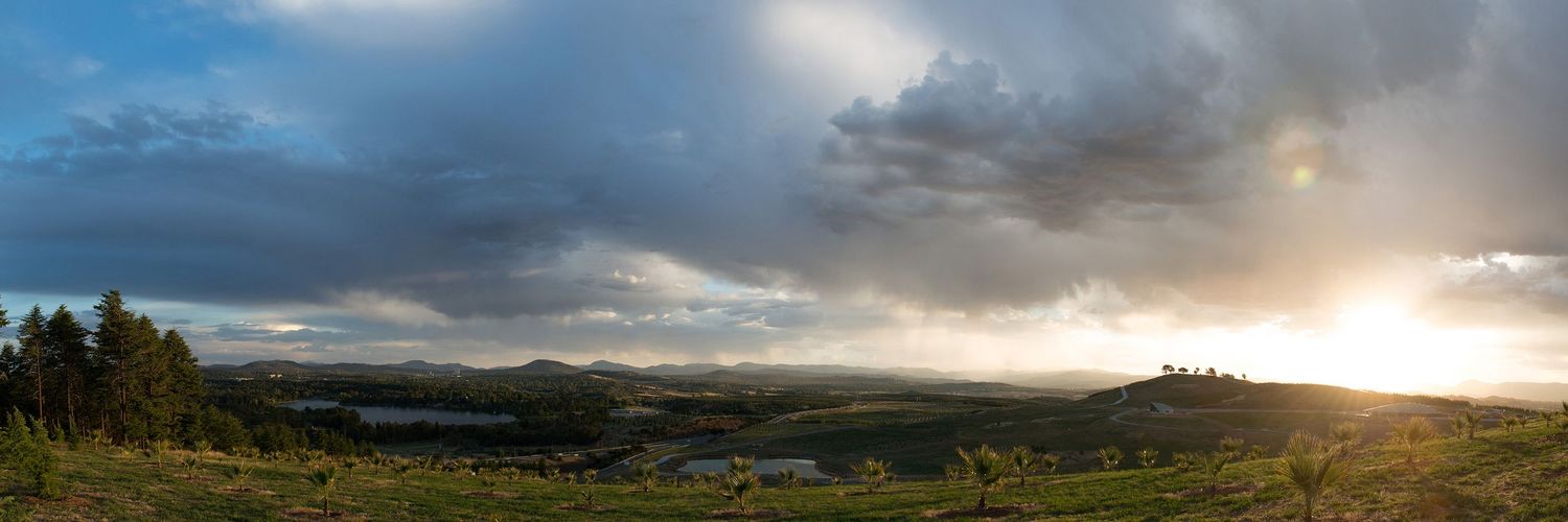 Panoramic landscape view of cloudy mountain scenery at sunset. Captured at the National Arboretum, Canberra ACT
