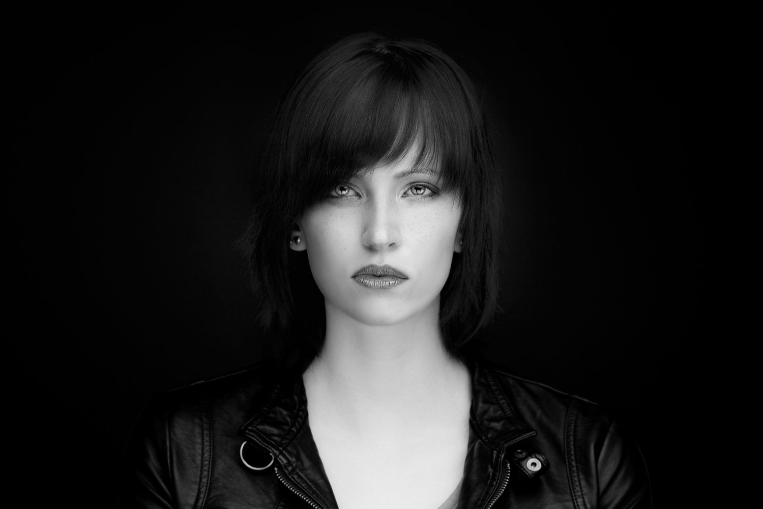 Dramatic black and white portraits with moody lighting and dark styling.