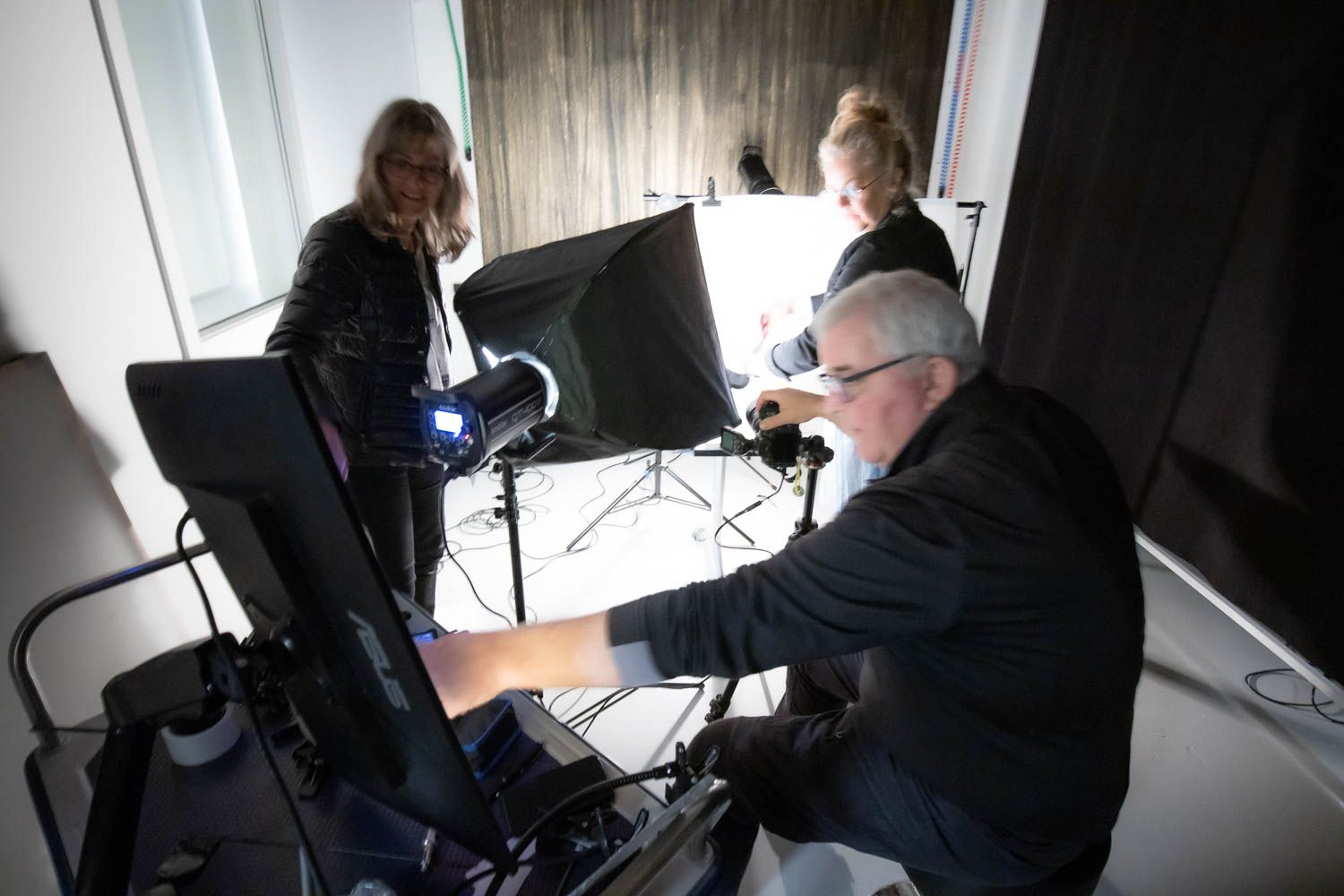 Professional photo studio setup with lighting equipment and camera gear arranged for a portrait session.