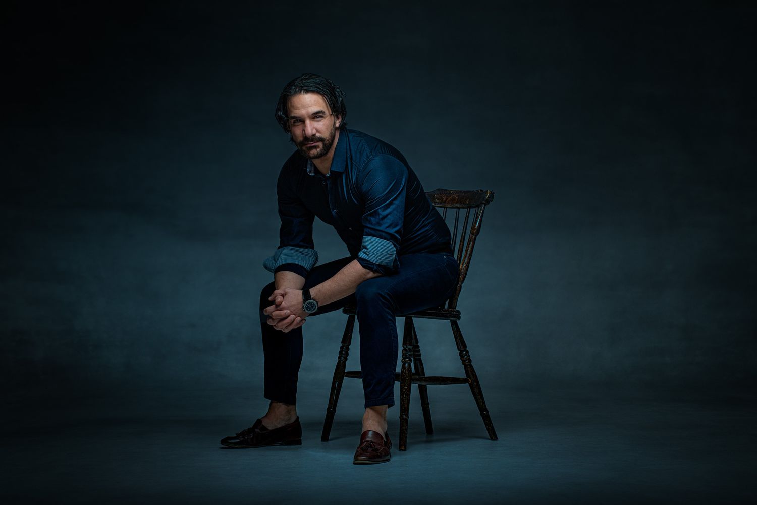 Artistic portrait series showing seated poses in formal attire against dark backdrop.