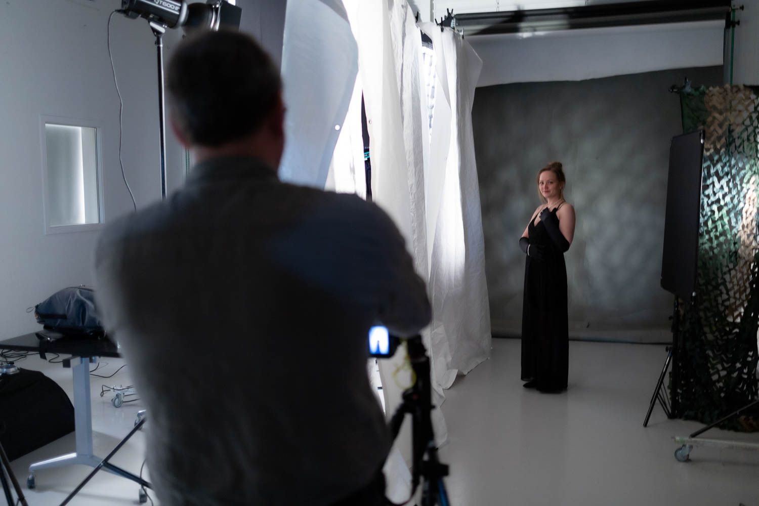 Wide shot of a photography studio showing lighting setup and equipment placement.
