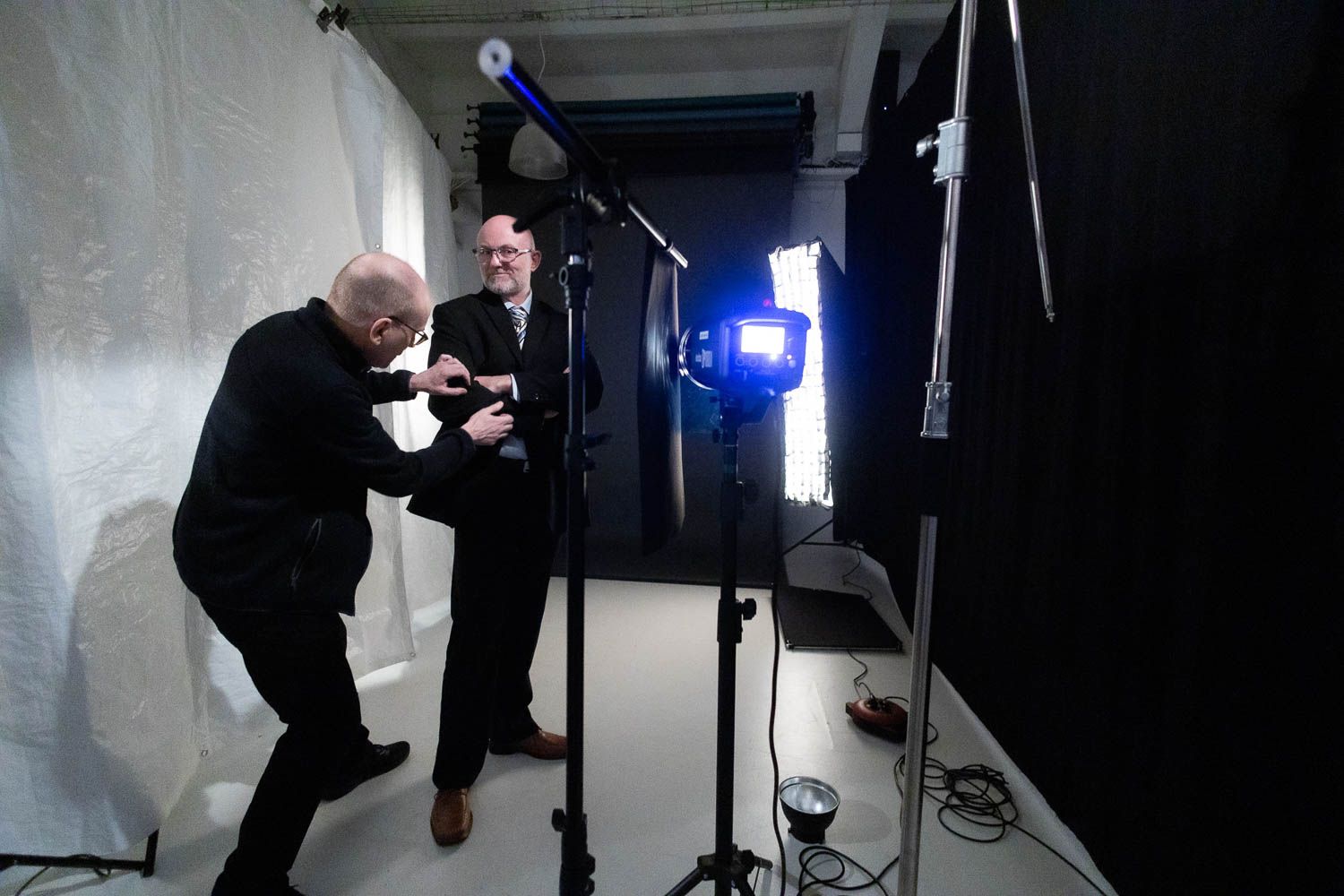 Low-angle view of photography studio setup with lighting equipment and shadows.