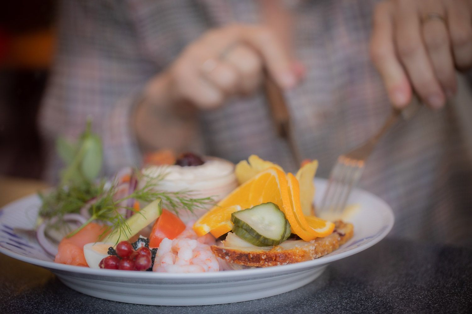 Colorful open-faced sandwich with fresh vegetables and garnishes.