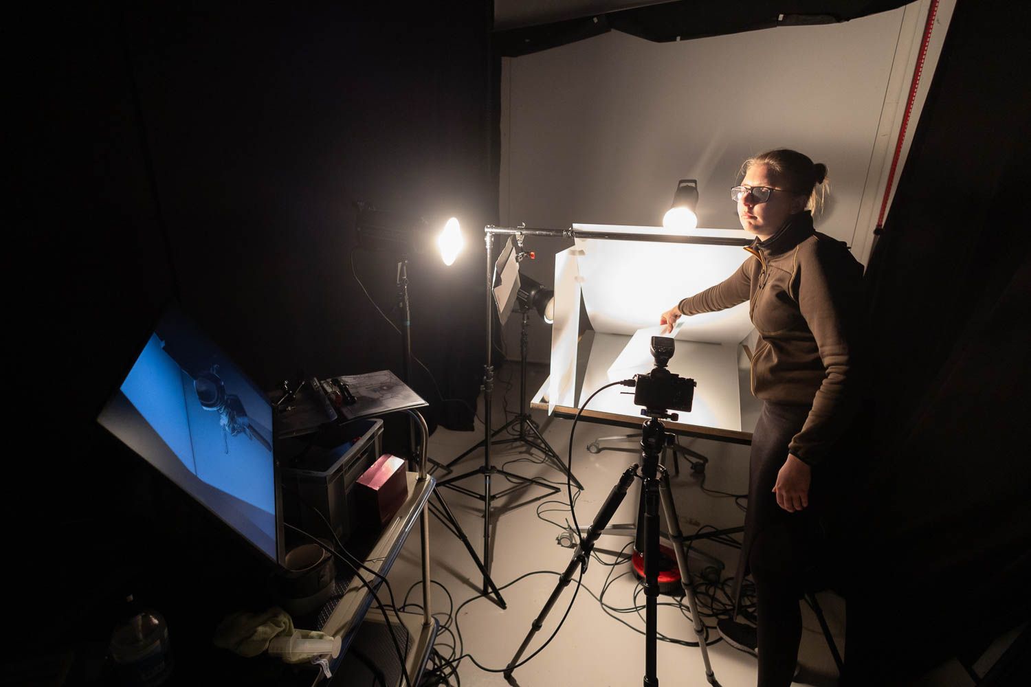 Studio photography setup with monitors and lighting equipment during professional shoot.