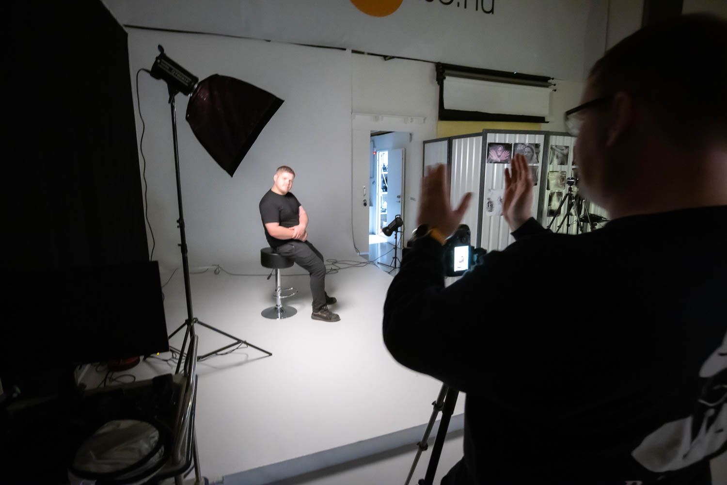 Photography studio setup with professional lighting and white backdrop during a commercial shoot.