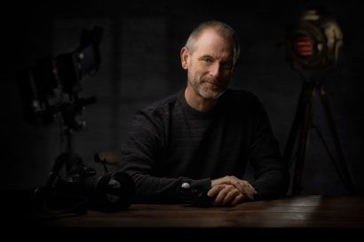 Creative portrait photography with dramatic low-key lighting in a studio.