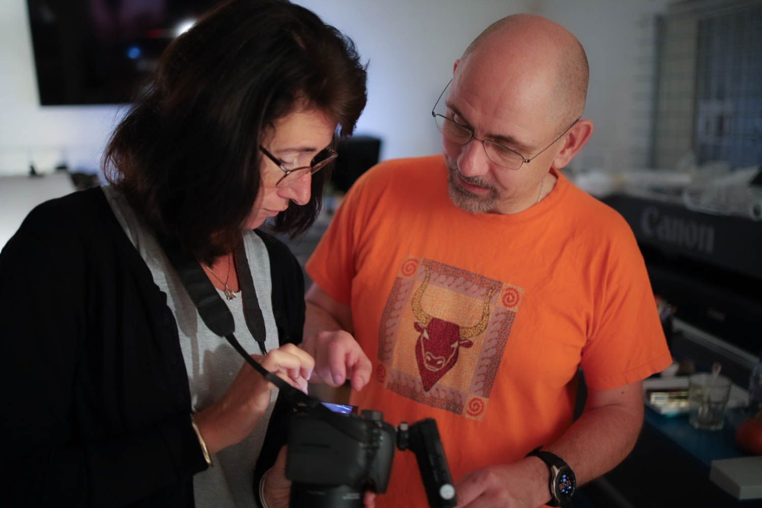 Photography team working in a studio with lighting and digital equipment.