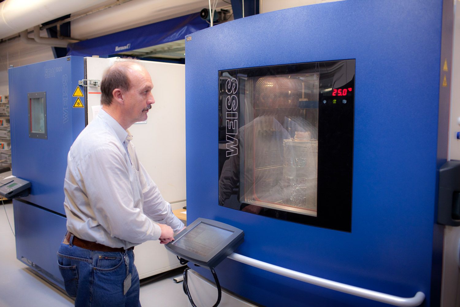 Modern laboratory space with blue walls and multiple testing stations.