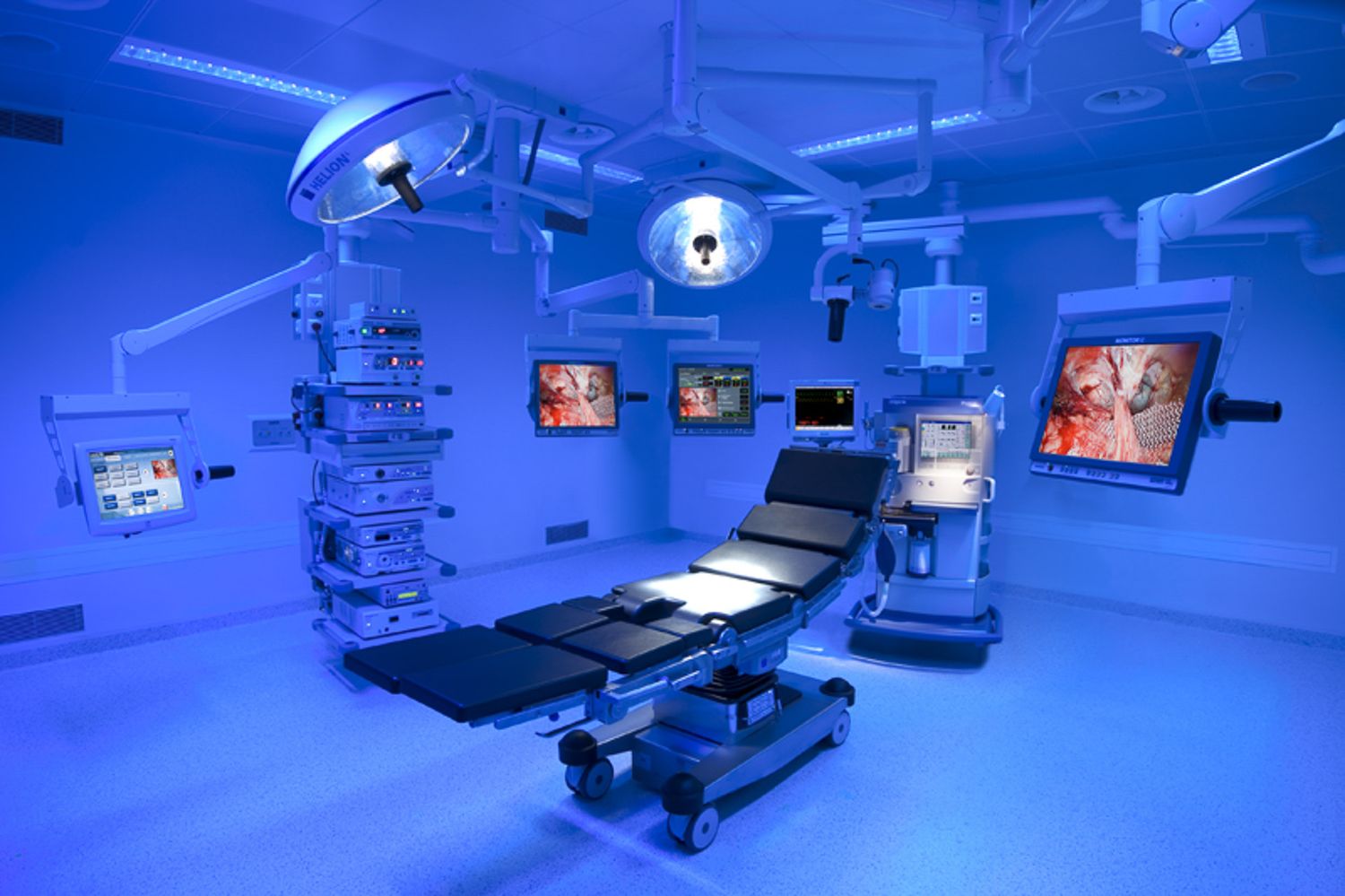 Modern surgical suite with multiple operating tables and advanced medical technology.