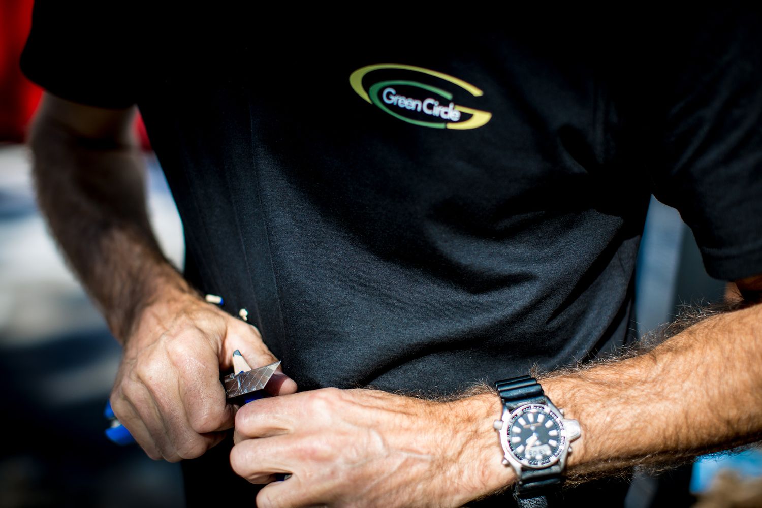 Close-up of hands working with technical equipment and tools.