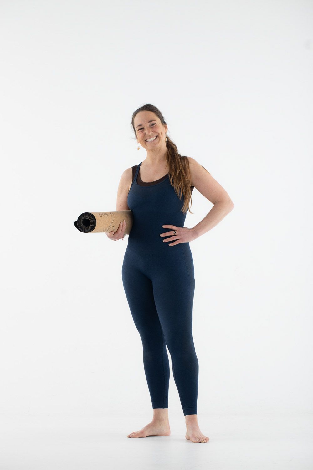Person demonstrating standing yoga stretches and movements in athletic wear.