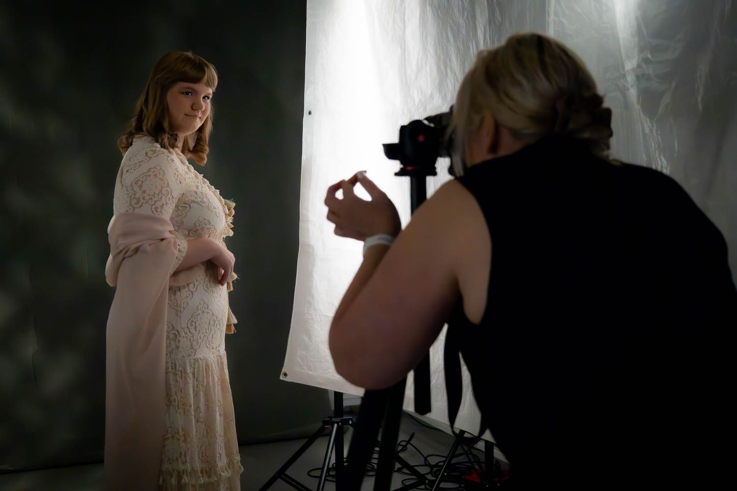 Moody studio photography session with dramatic backlighting and fog effects.