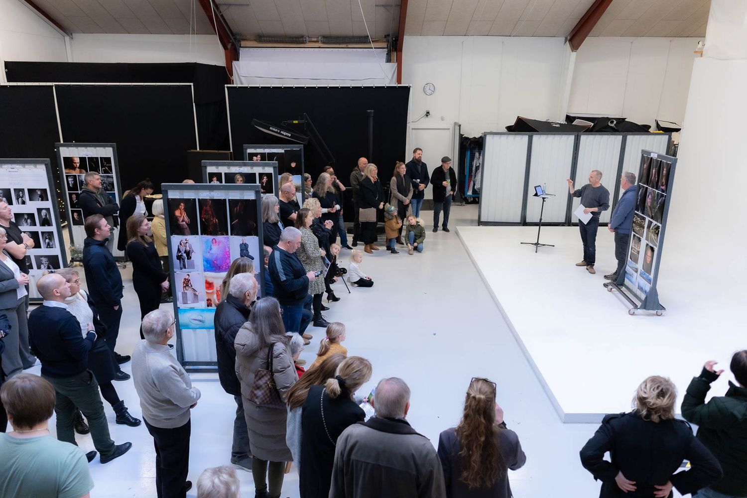 Photography studio interior with people attending a workshop or training session.