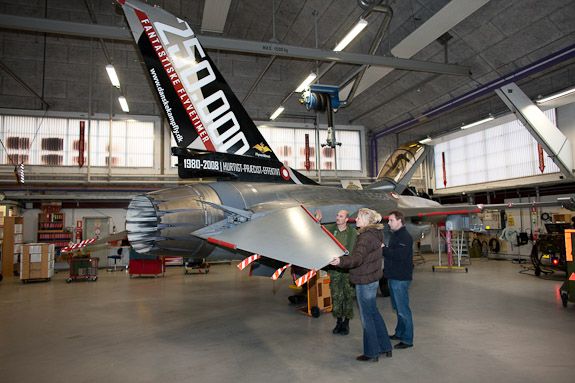 Large industrial hangar or warehouse space with aircraft equipment visible.