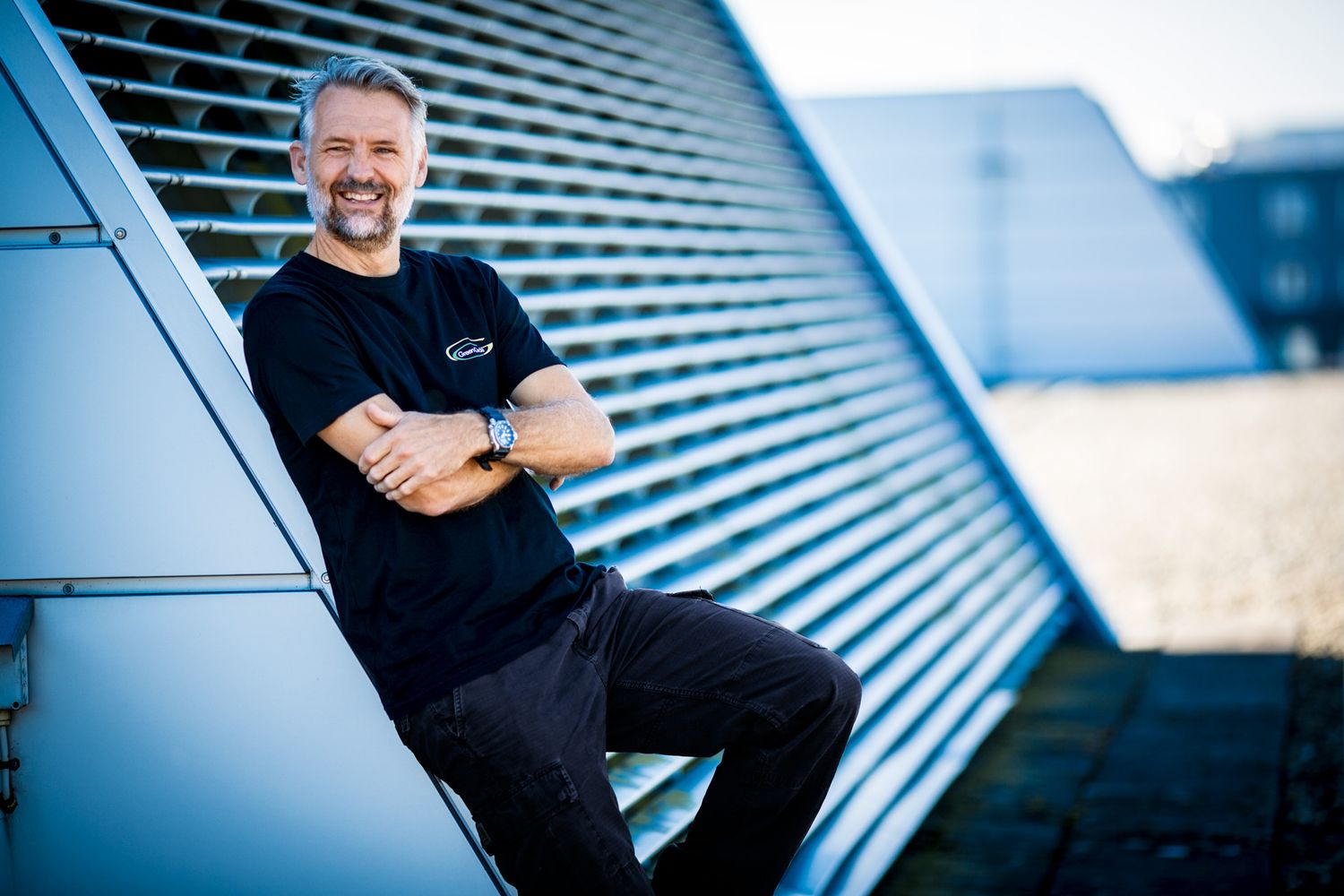 Modern architectural detail showing blue metal panels and geometric lines.