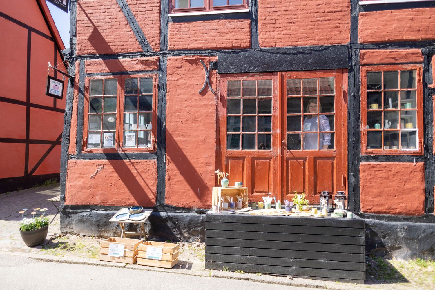 Traditional red brick building exterior with timber frame details and multiple windows.