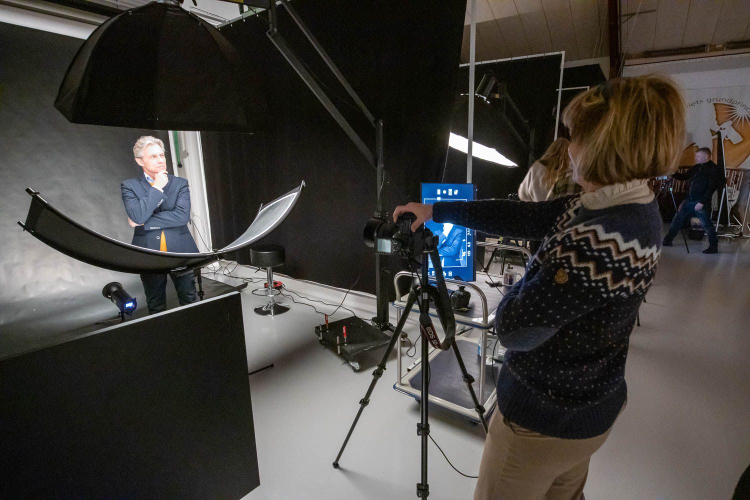 Professional photo shoot setup with large softbox and camera equipment in studio.