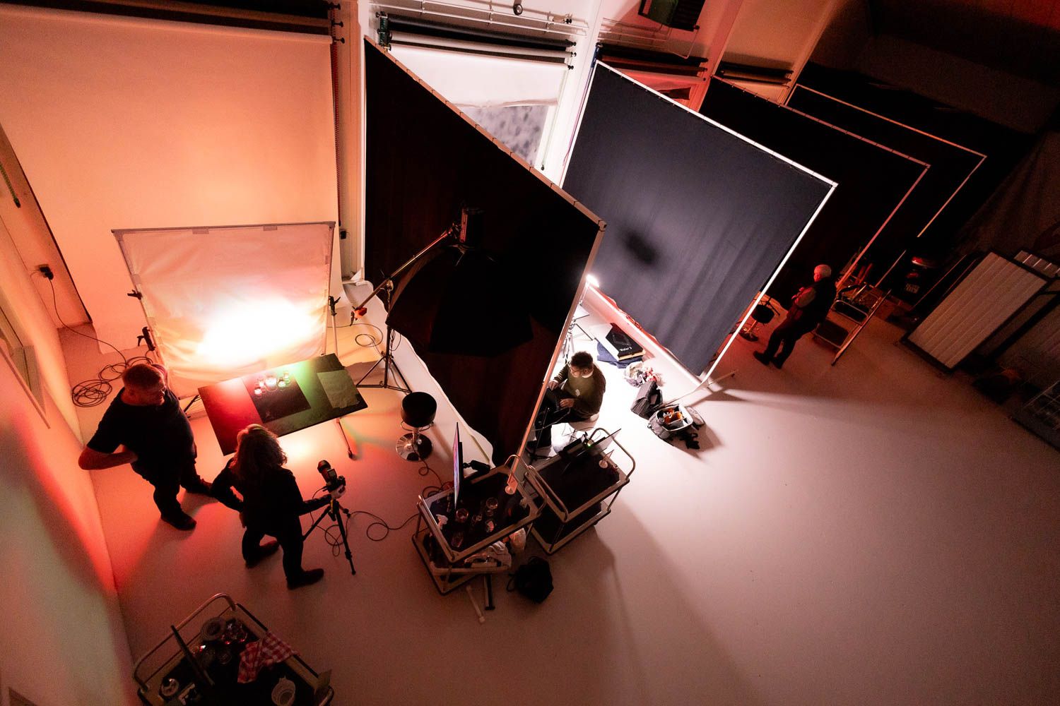 Overhead view of a photography studio with warm lighting and professional equipment setup.