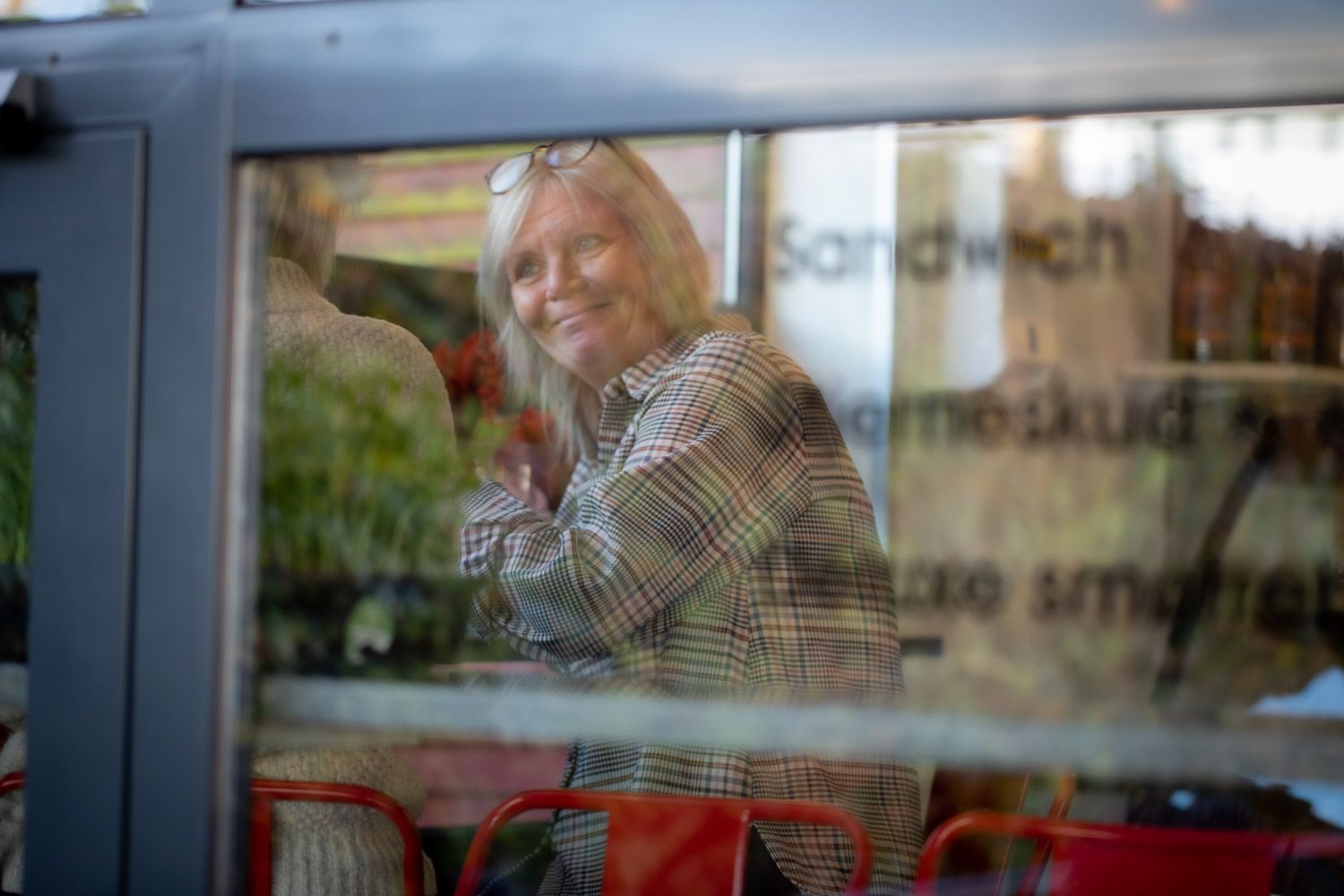 View through window of cafe interior with reflective glass.