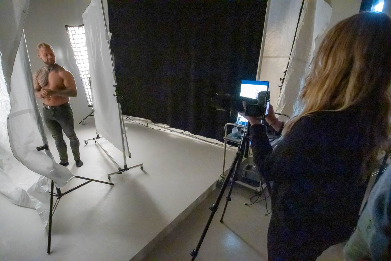 Photography session in progress with studio lighting and white backdrop setup.