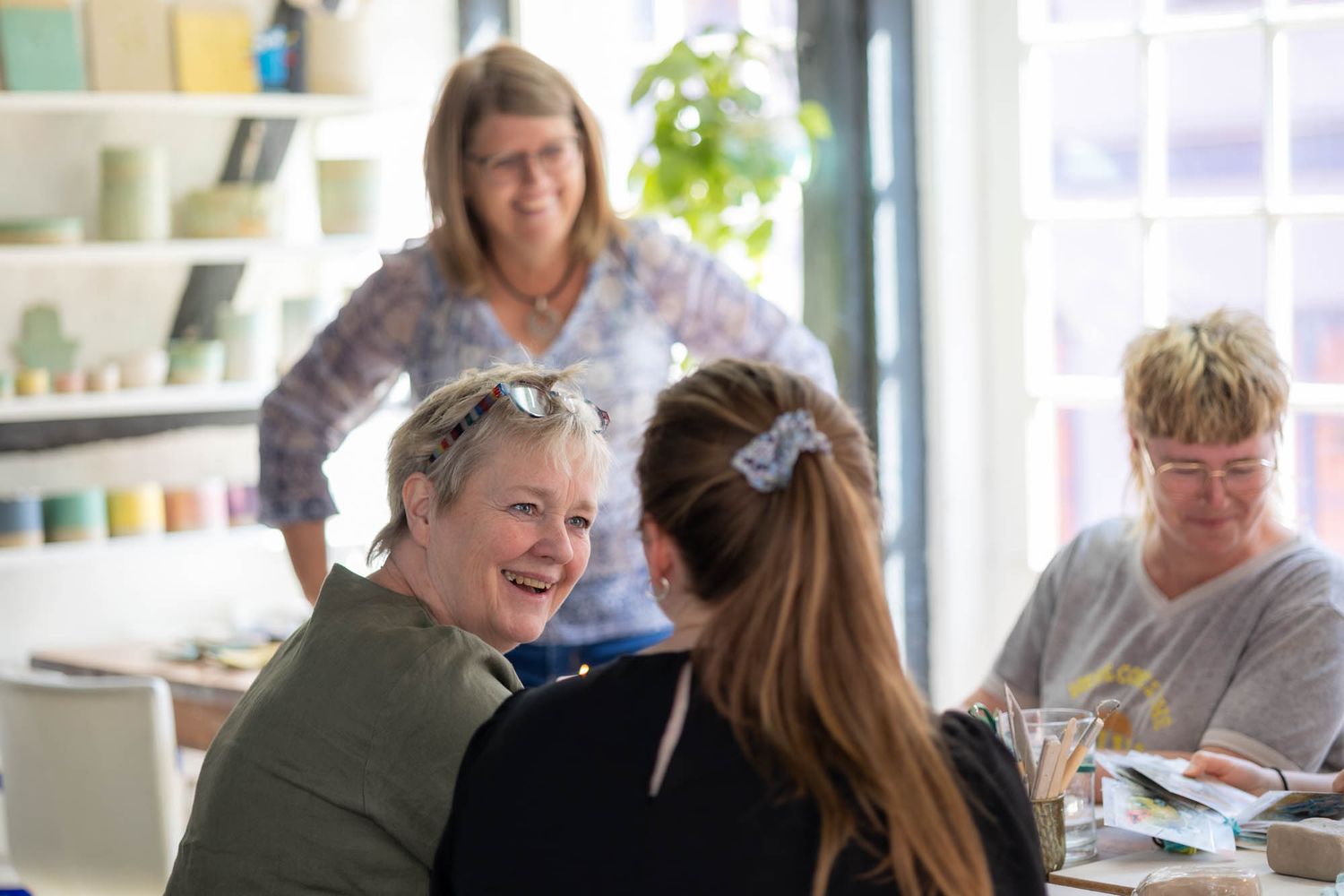 A small group shares a lighthearted moment during an informal meeting.