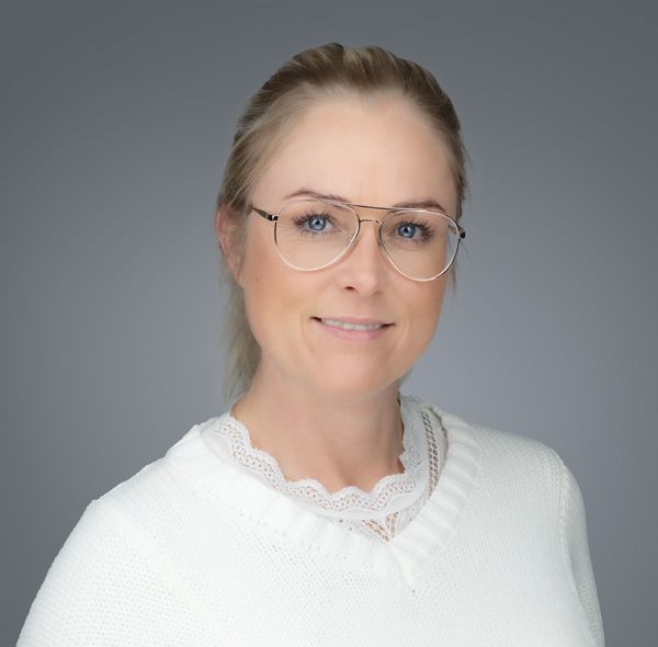 Professional headshots against a grey background featuring white lace clothing and glasses.