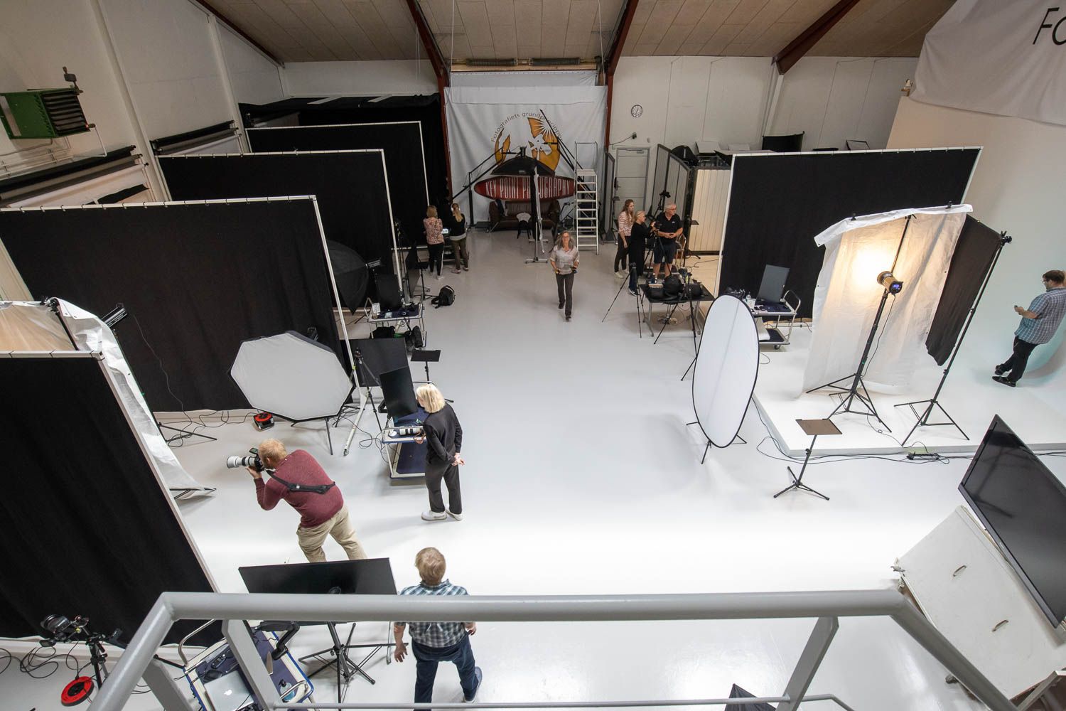 Wide view of photography studio interior with lighting setup and equipment.