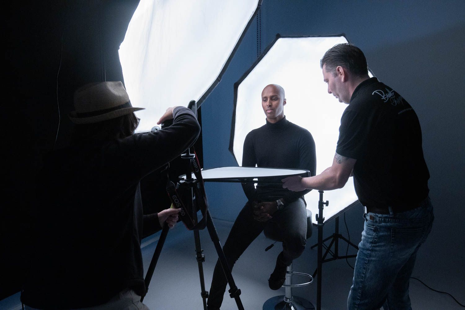 Professional studio photography setup with lighting equipment and camera gear during a photo session.