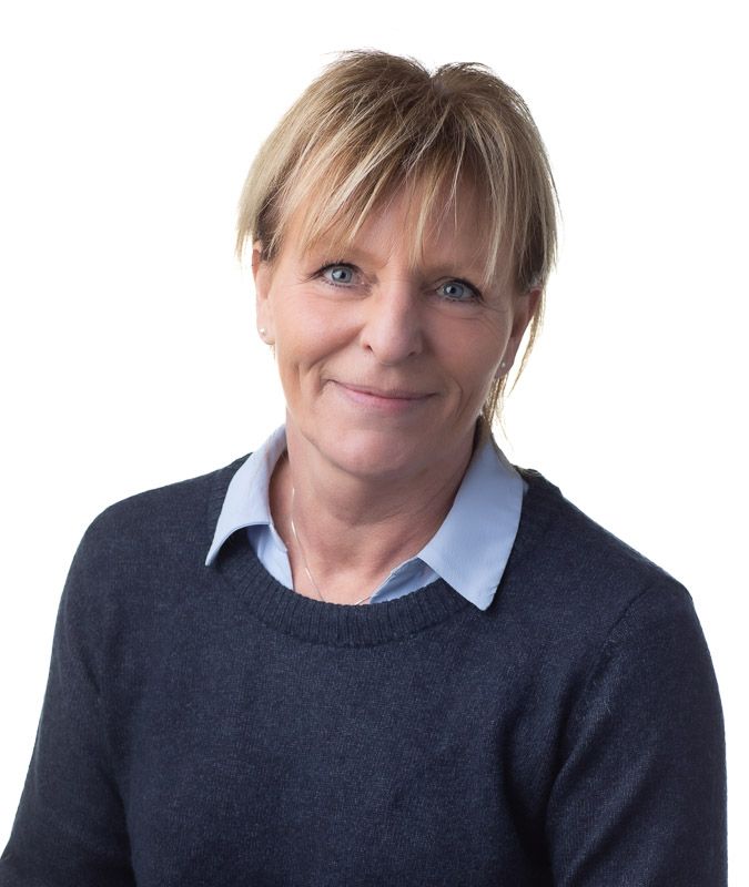 Professional headshot series showing different expressions against dark background in navy sweater and white collar.