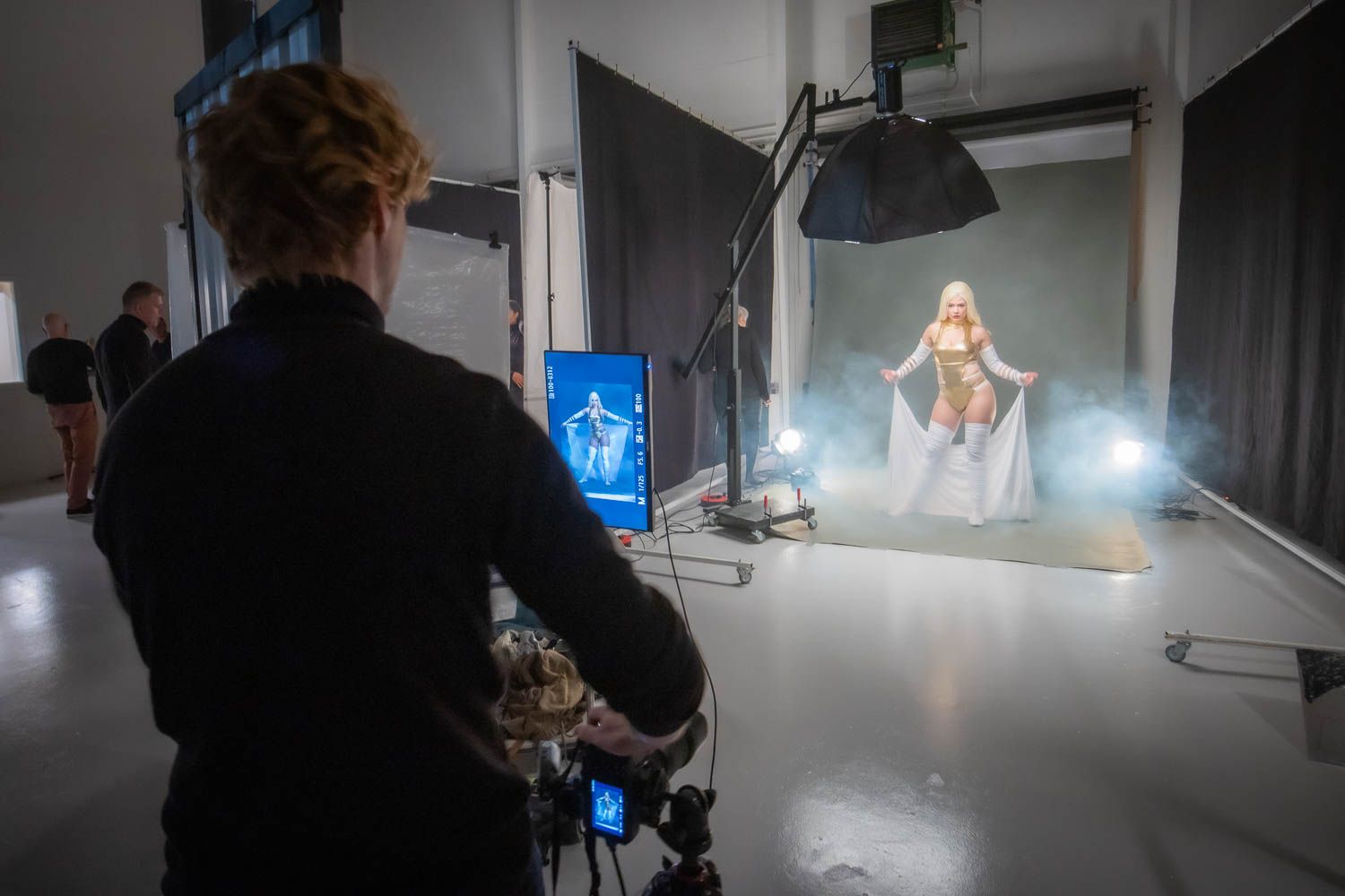 Dark studio space with professional lighting equipment and camera setup.