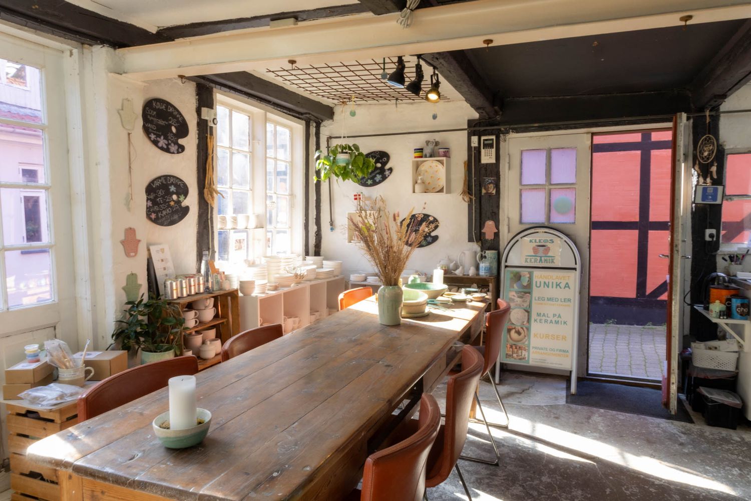 Rustic interior of a cozy restaurant with wooden beams and natural lighting.