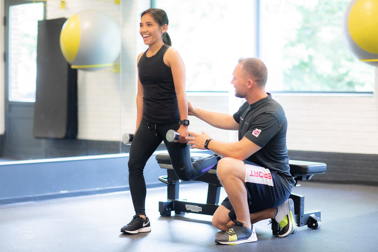 Training session in progress with exercise equipment and yellow stability balls visible in background.