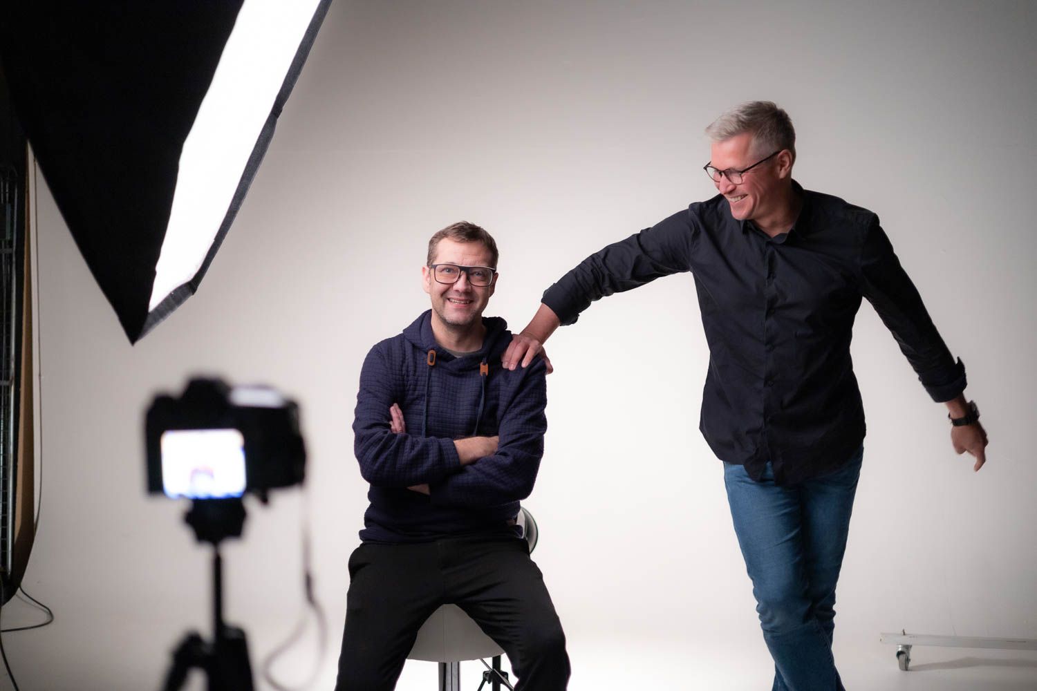 Professional photography session setup with studio lights against a white backdrop.