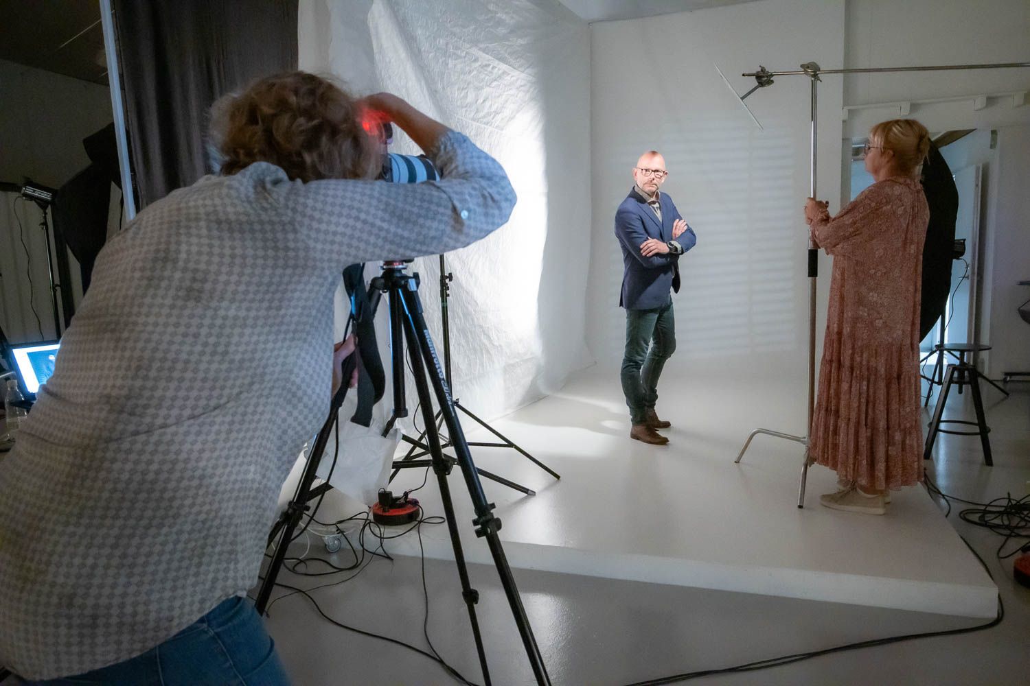 Panoramic view of photography studio setup with equipment and crew.