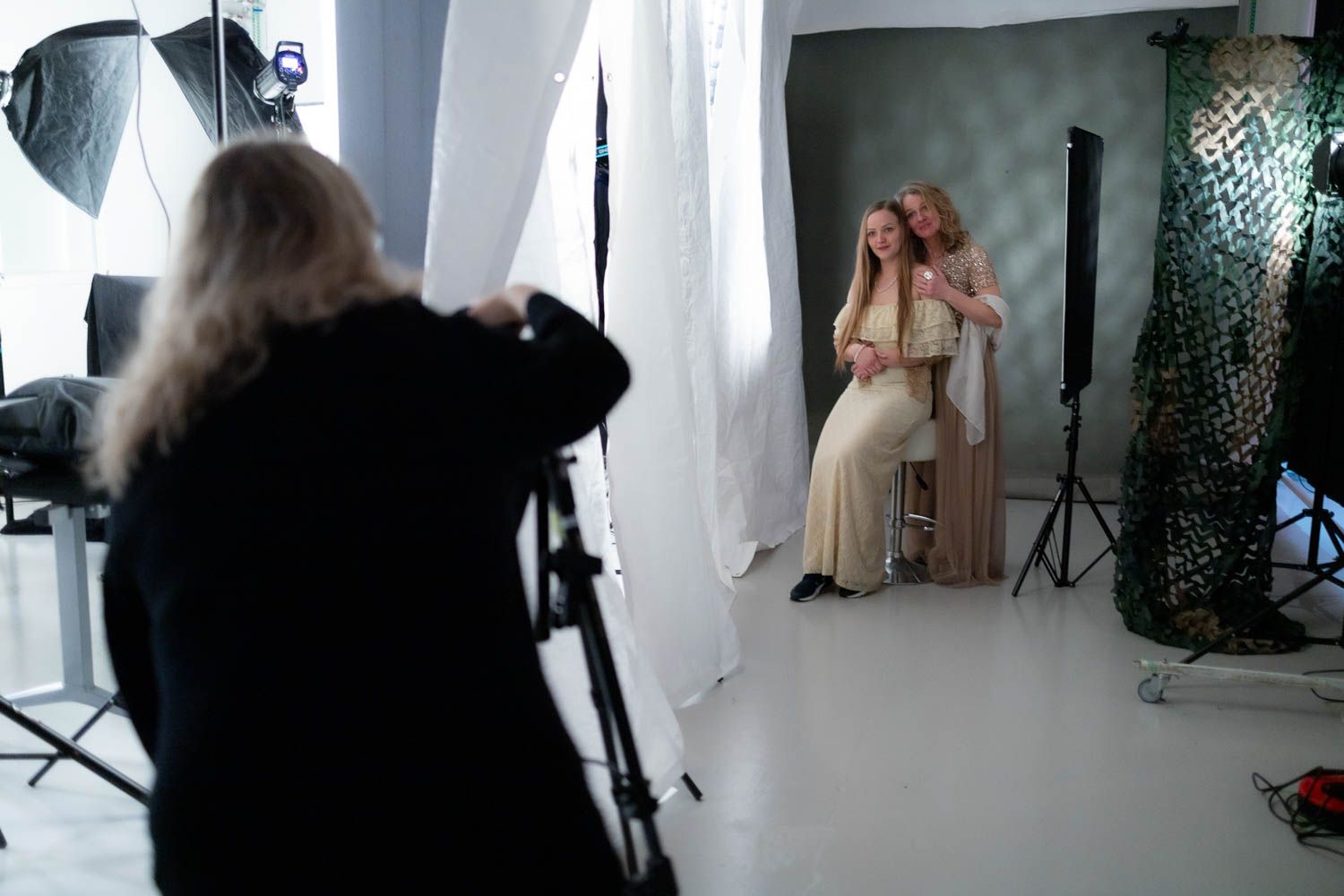 Behind-the-scenes view of a professional photo shoot with studio lighting and equipment.