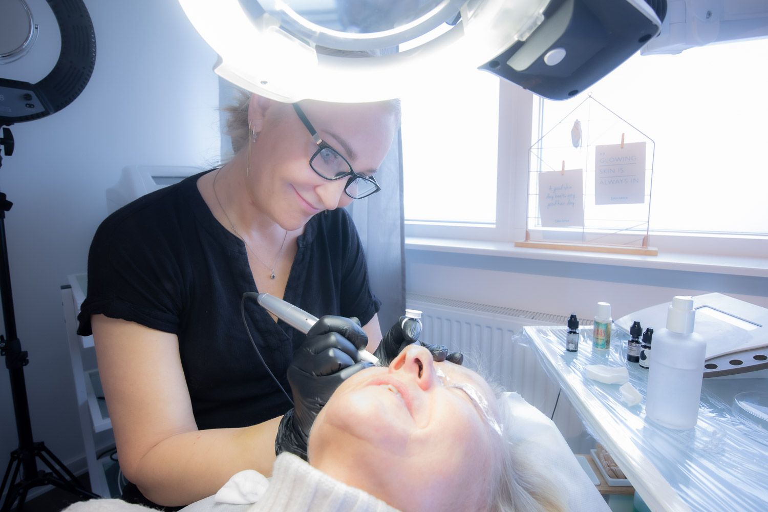 Professional skincare treatment being performed under bright LED lighting.