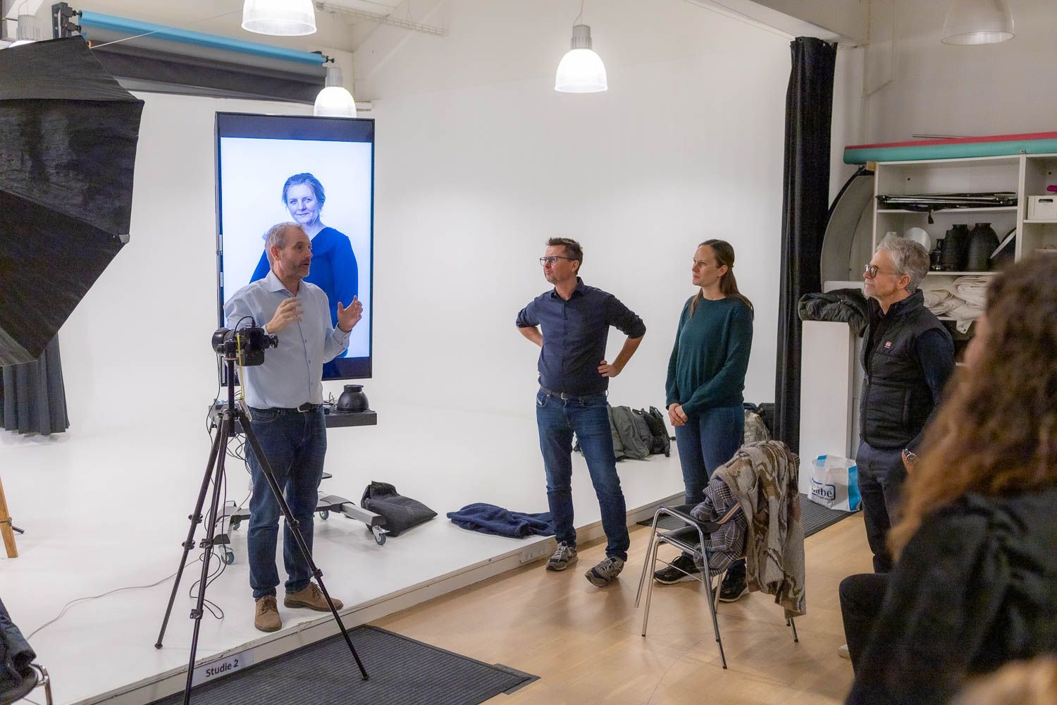 Behind the scenes of a professional photo shoot in a studio setting.