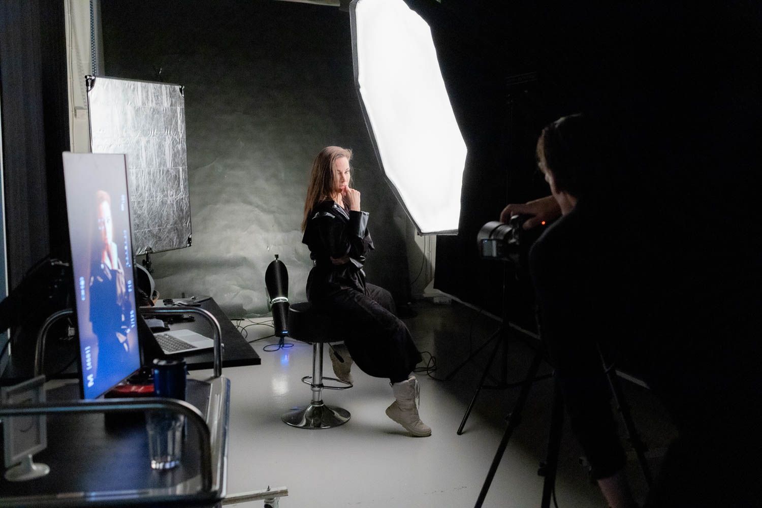 Dramatic low-light studio photography setup with professional lighting equipment.