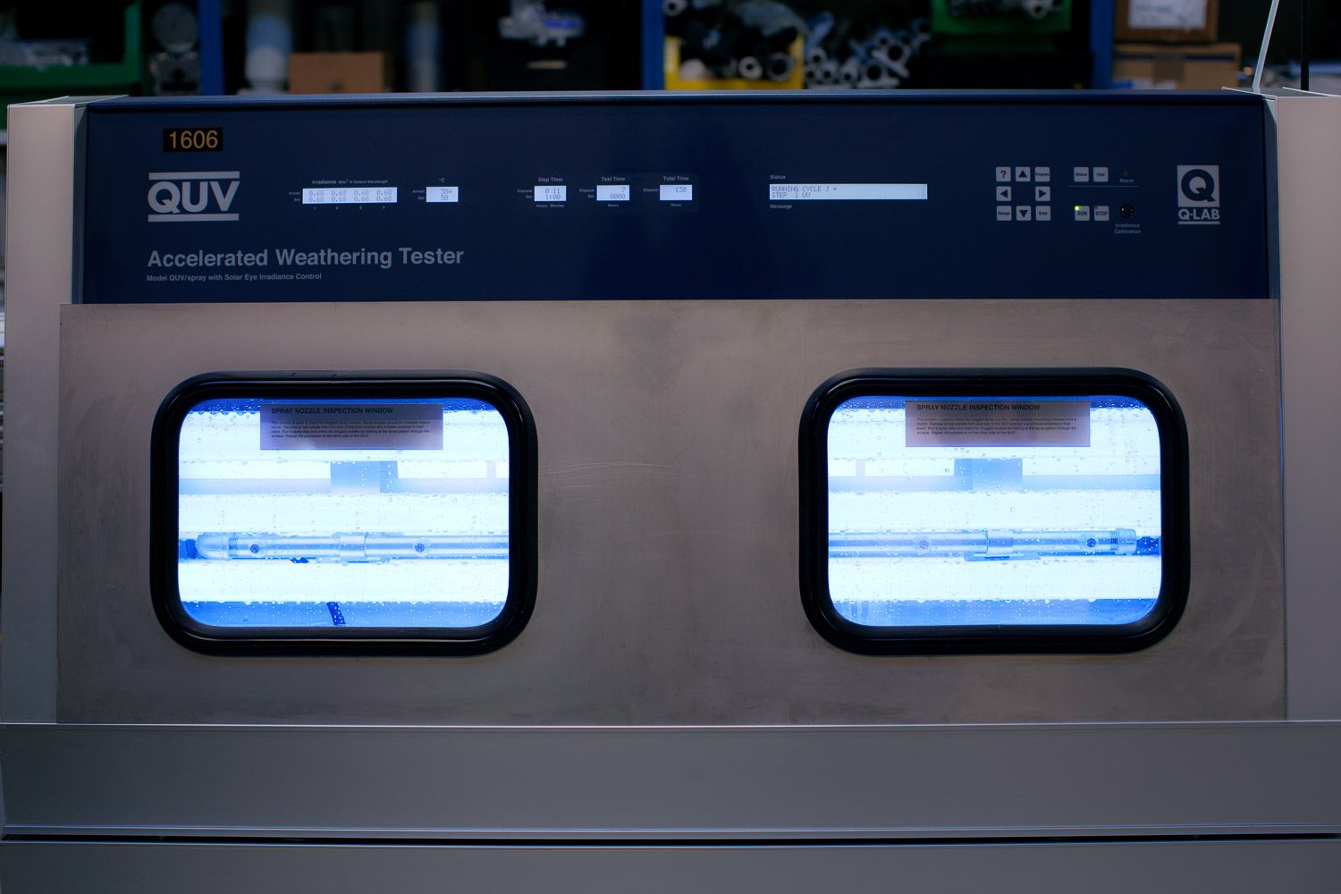 Close-up of scientific equipment display panel with two illuminated screens.