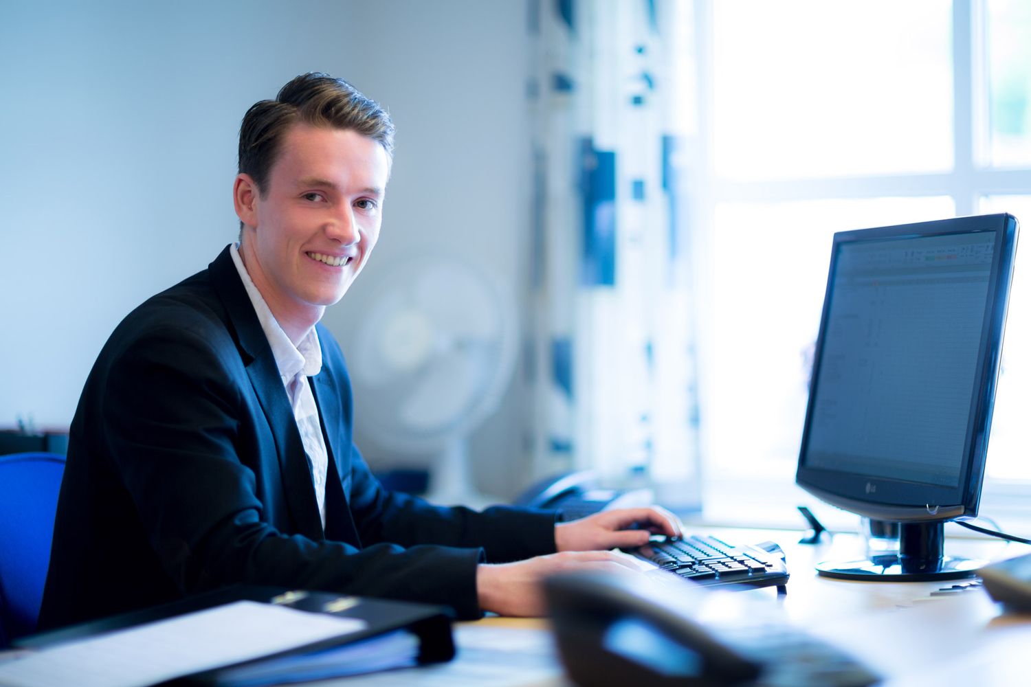 Business professionals working in bright modern office environment.