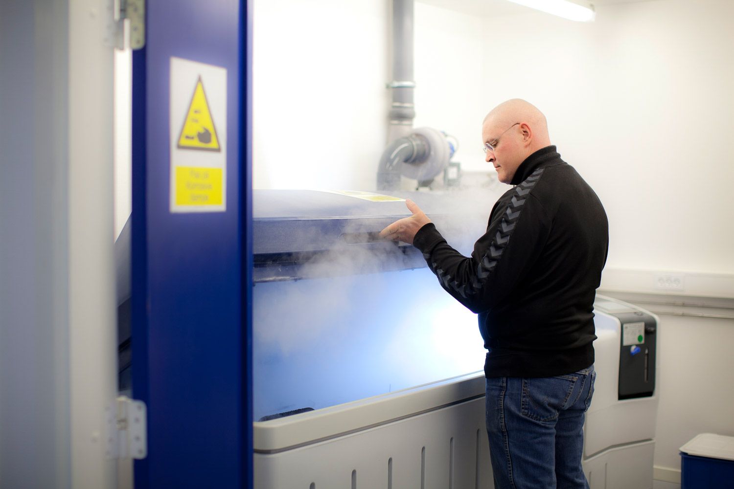 Testing facility interior with blue walls and white equipment installations.