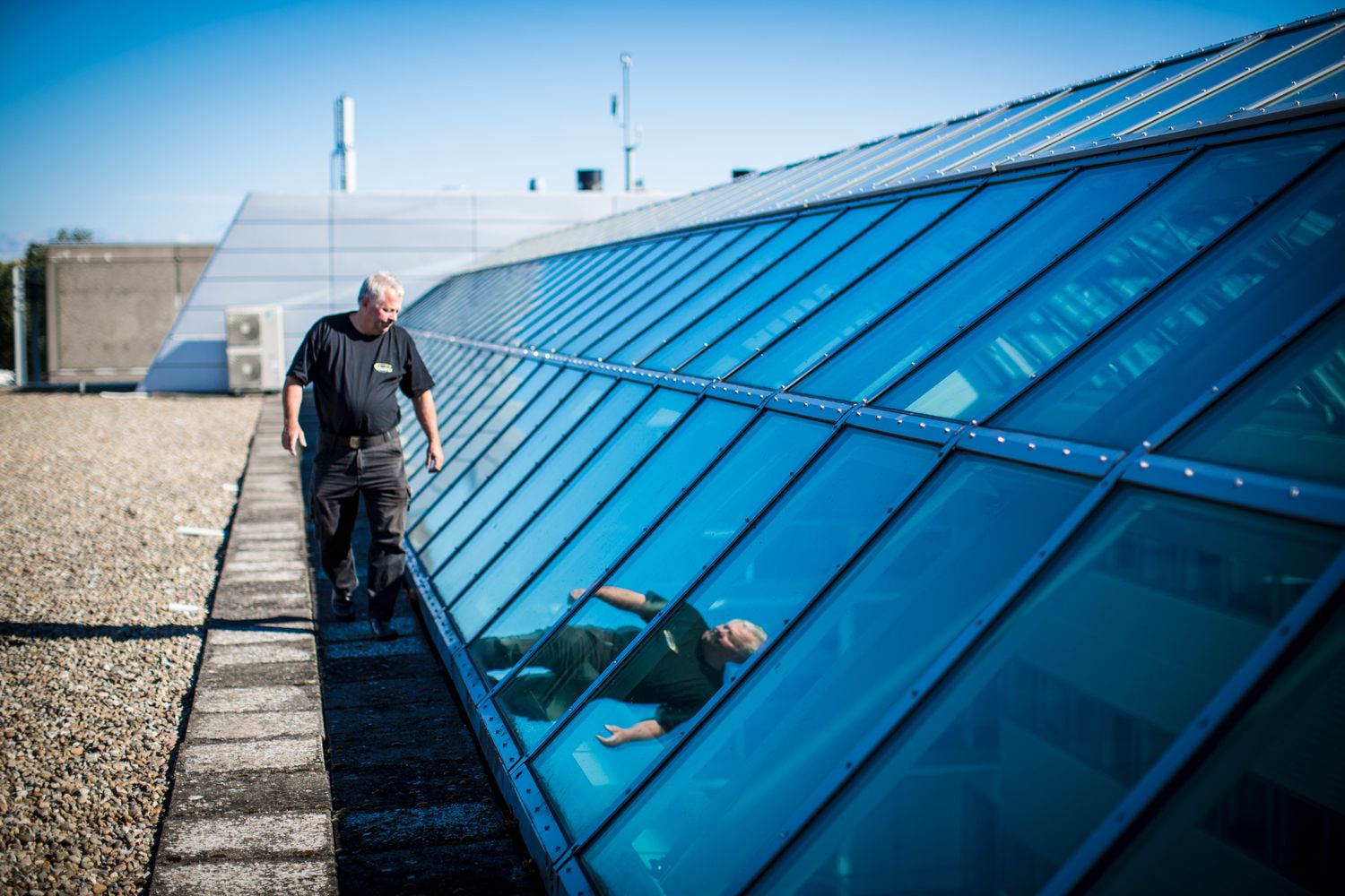 Large blue solar panels installed on a commercial building rooftop.