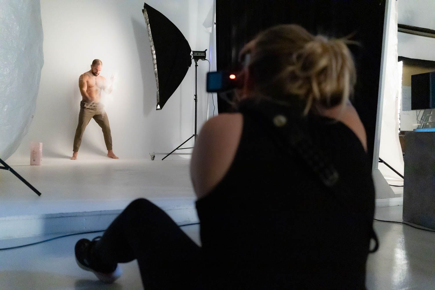 Professional photography studio setup with lighting equipment and white backdrop for product shoot.