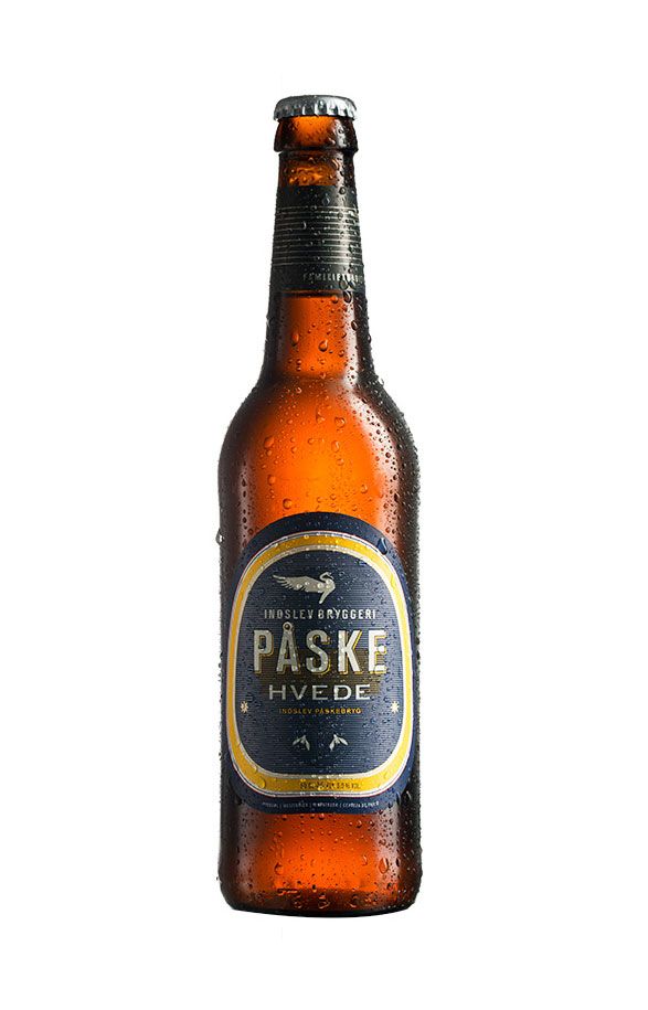 Amber beer bottles of Paske craft brew with dark labels and condensation.