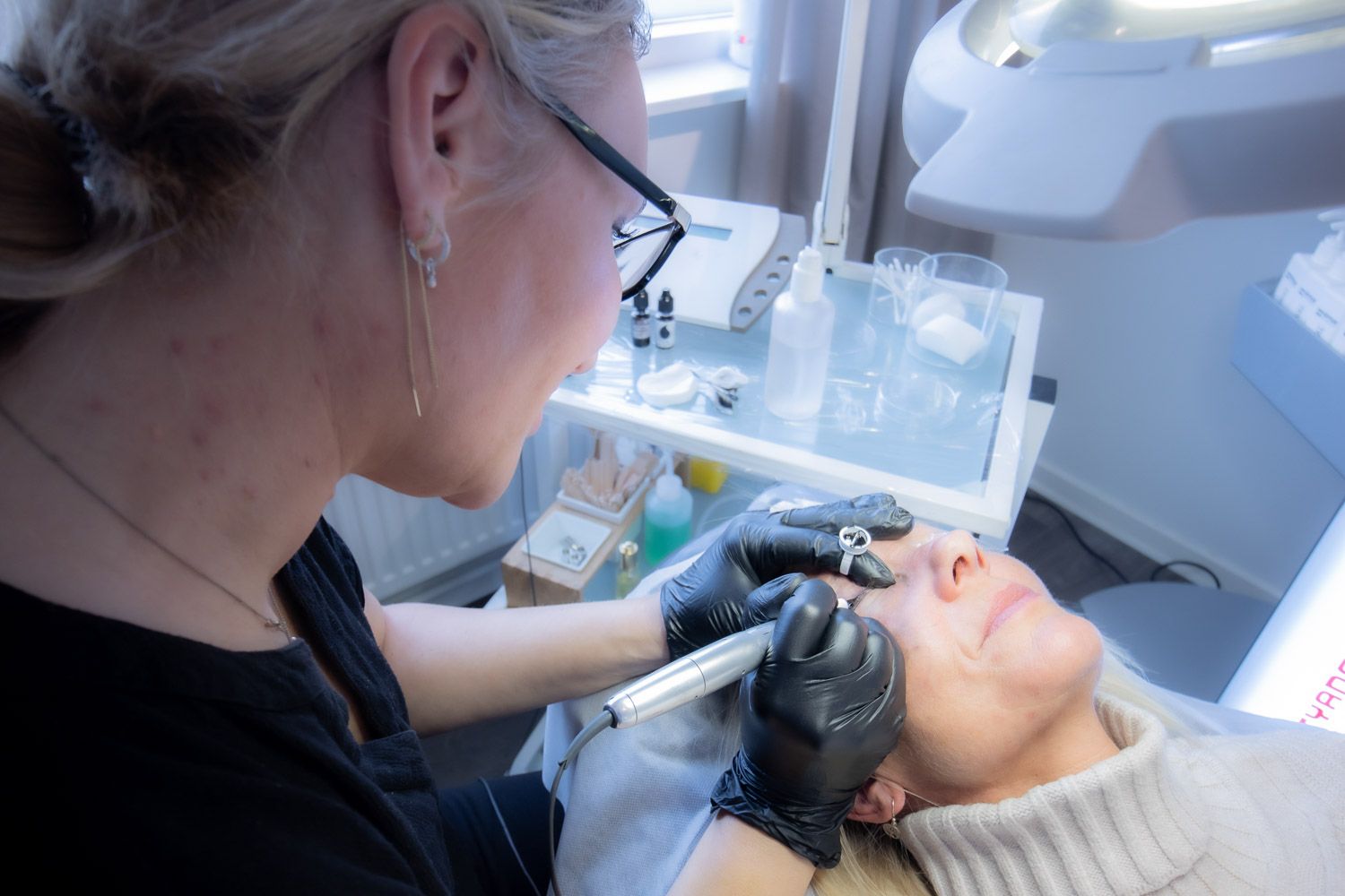 Close-up of a professional beauty treatment being performed in a bright medical spa setting.