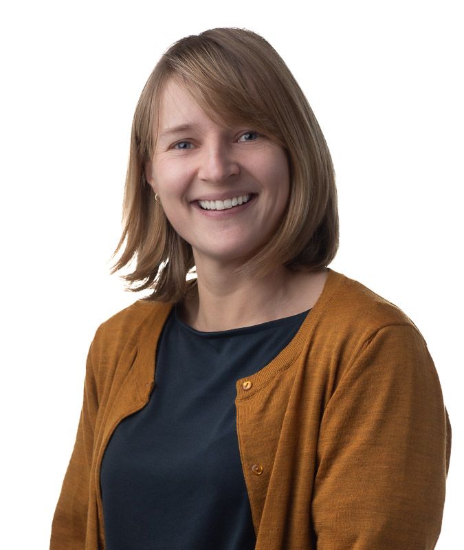 Professional portrait series showing warm smiles while wearing brown cardigan.